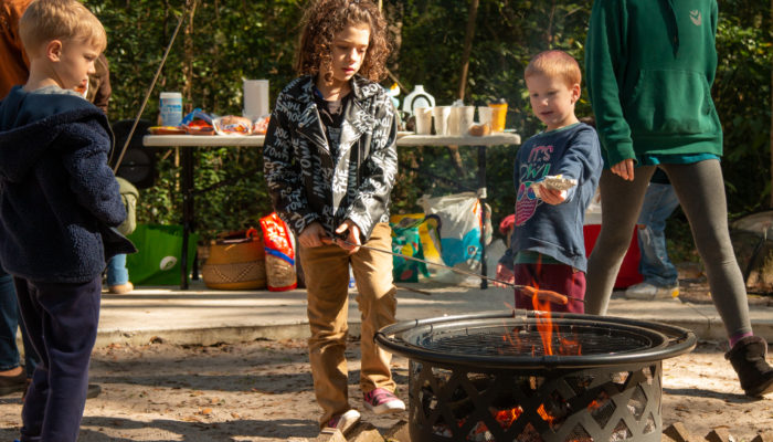 Children roasting hot dogs